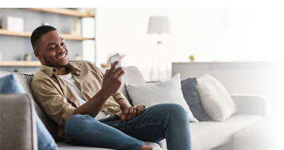 Member sitting on couch looking at phone